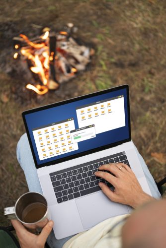 person-remote-working-while-camping-site